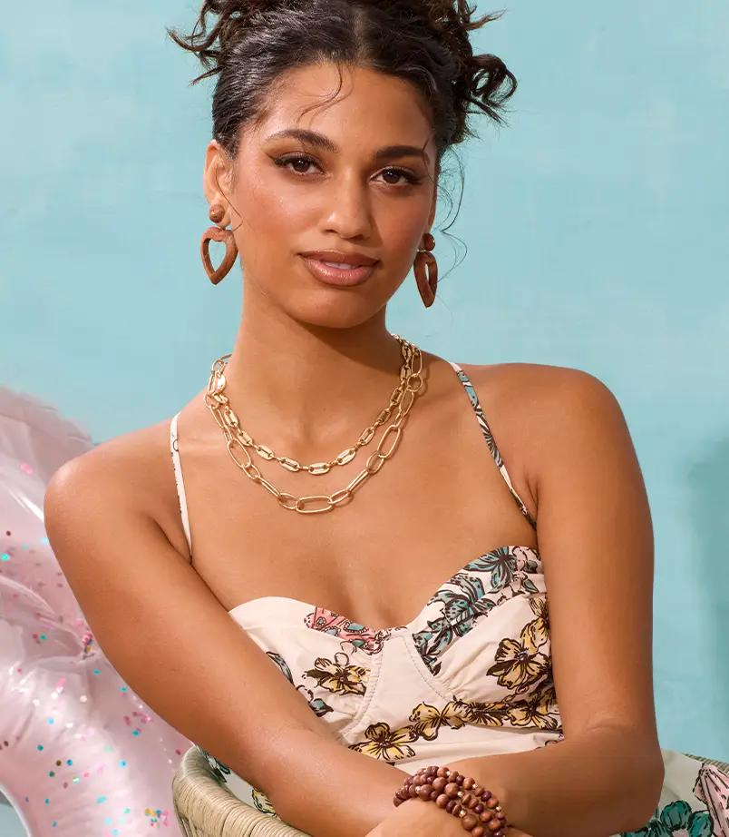 Model wearing bold blush & cream colored earrings