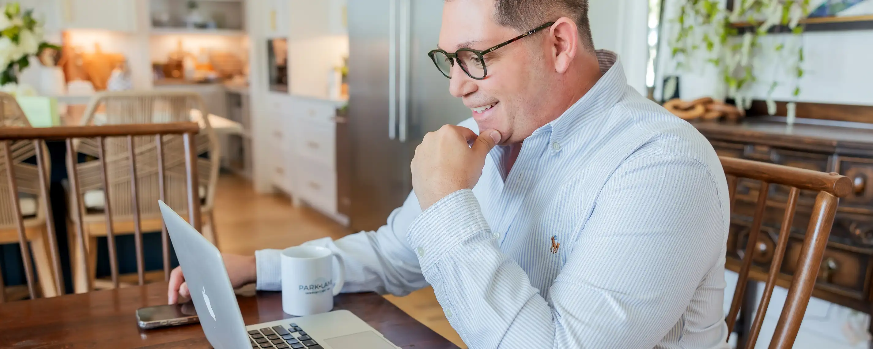 A man intensly looks at his laptop, working on parklane orders