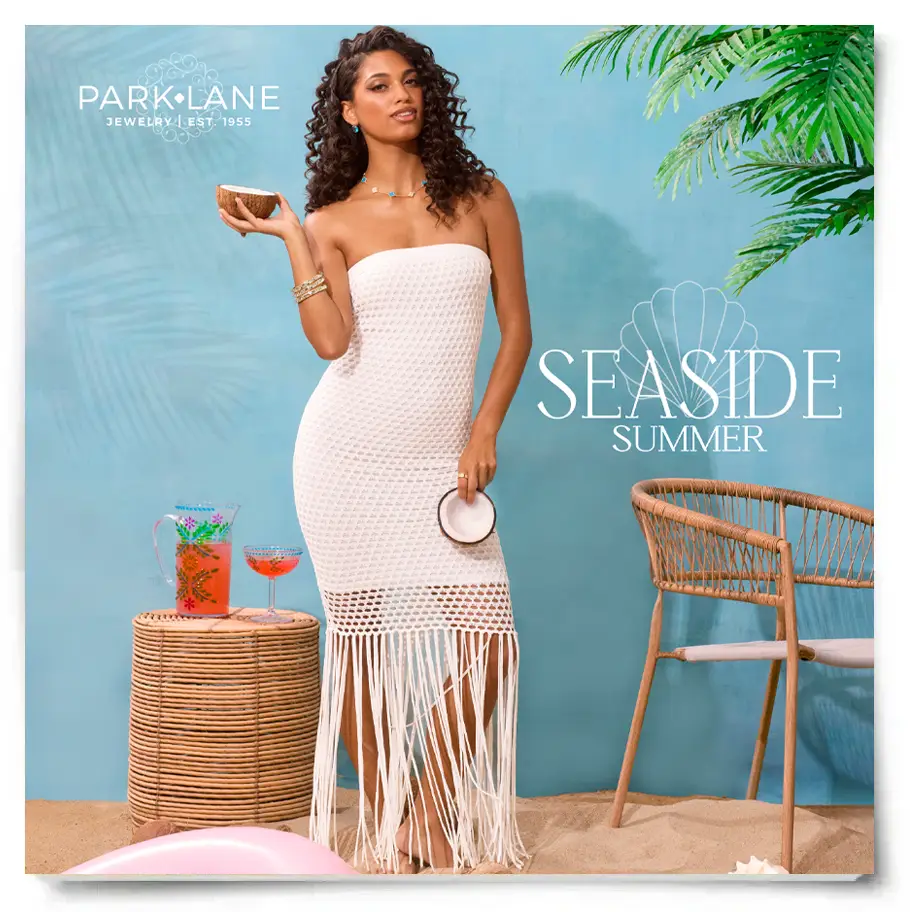 Woman wearing a white crochet fringe dress and turquoise jewelry in a tropical beach-themed summer fashion scene with wicker furniture and seaside decor.