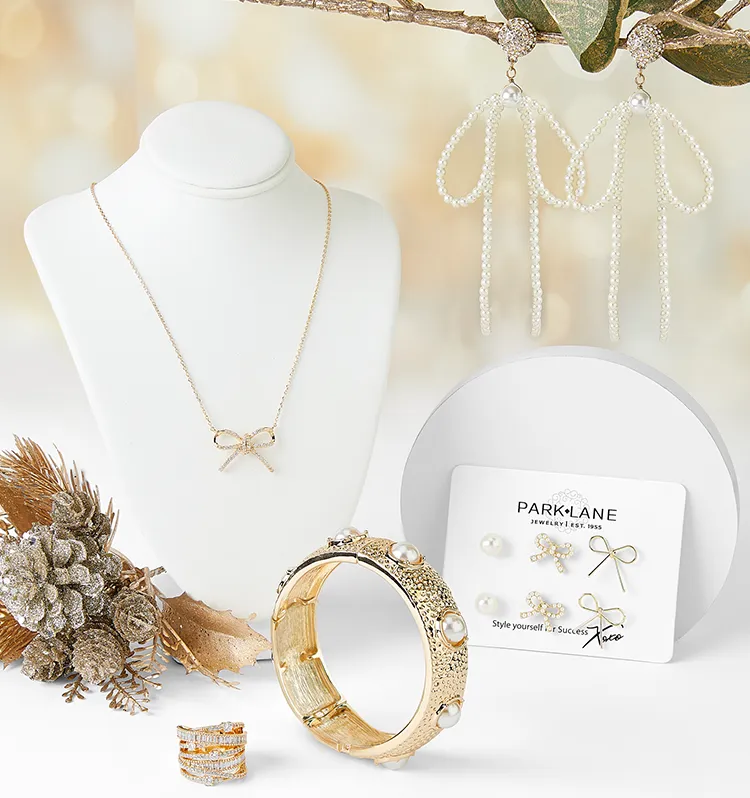 Flatlay of Glitz & Glam jewelry. Gold & gem earrings, pearl earrings, gold necklaces